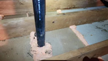 Spray foam sealing pipe penetration in attic floor