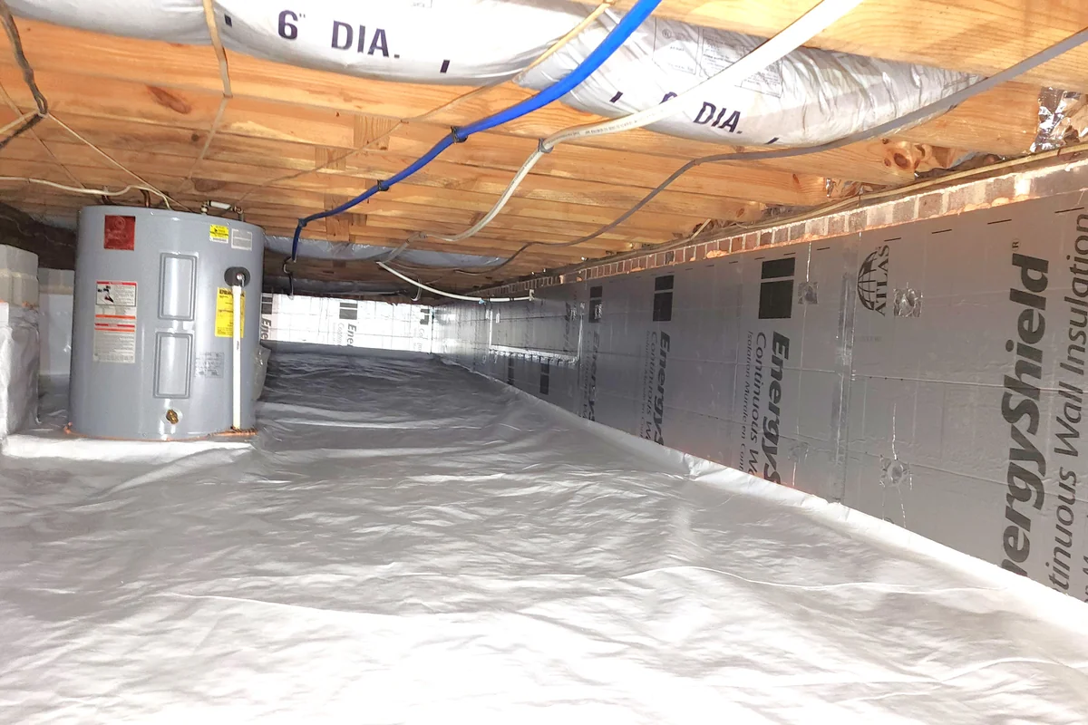 Encapsulated crawl space in Apex NC with rigid foam wall insulation, sealed vapor barrier, conditioned ductwork, and clean mechanical equipment install — completed by Peak Energy