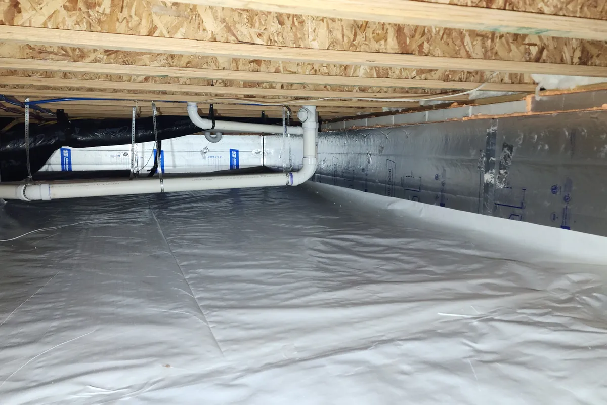 Sealed crawl space with a vapor barrier run up the foundation walls and foil-faced insulation in a Triangle NC home